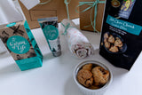 Assorted products including Byron Bay cookies, skincare items, and a baby muslin wrap, baby hamper australia, baby gifts, corporate baby gift Australia.