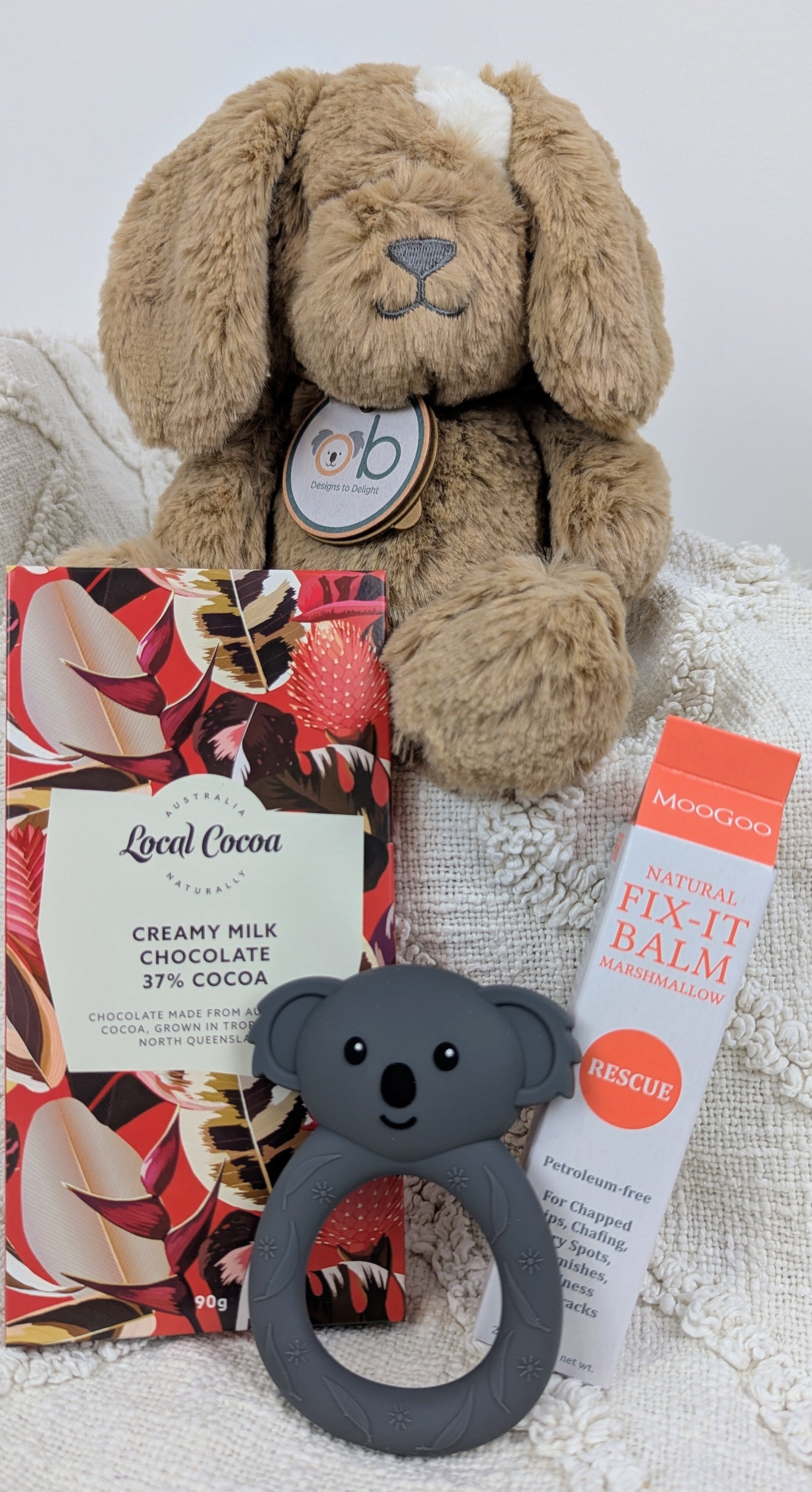 Soft dog toy, Local Cocoa chocolate bar, and Moogoo Fit It balm. Baby hamper Australia. Baby boy hamper. Baby girl hamper. Baby gifts australia.