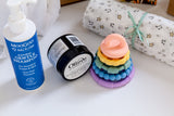 Moogoo baby shampoo bottle, Olieve jar, and colorful baby teether stacking rings. Baby hampers Australia, baby gifts, baby hampers. Maternity leave hampers Australia